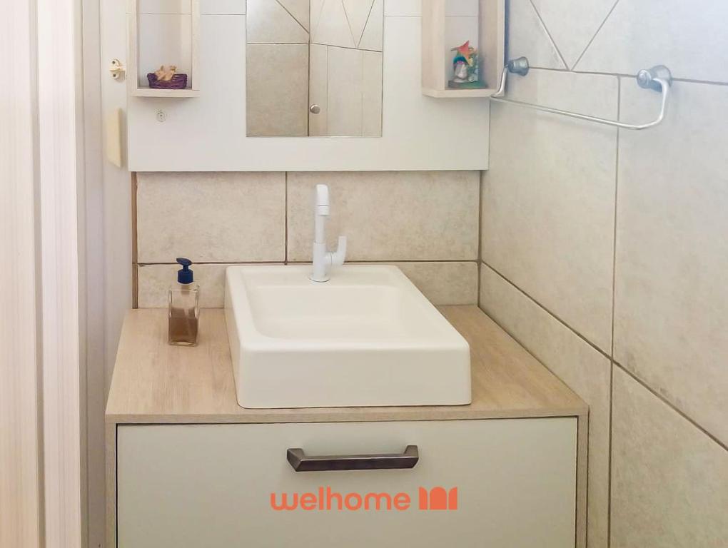 a bathroom with a white sink and a mirror at Cobertura com Vista e Conforto no RS in Santo Ângelo