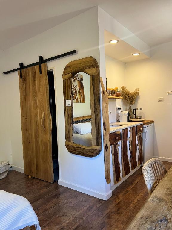 a room with a mirror on the wall and a kitchen at Unique Suite In Eilat in Eilat
