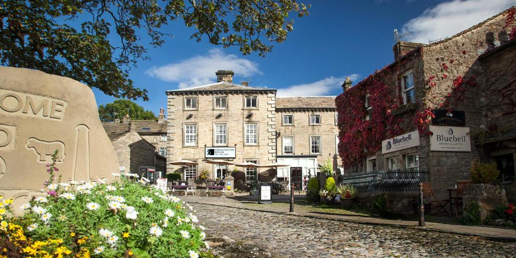 a cobblestone street in front of an old building at Grassington House in Grassington