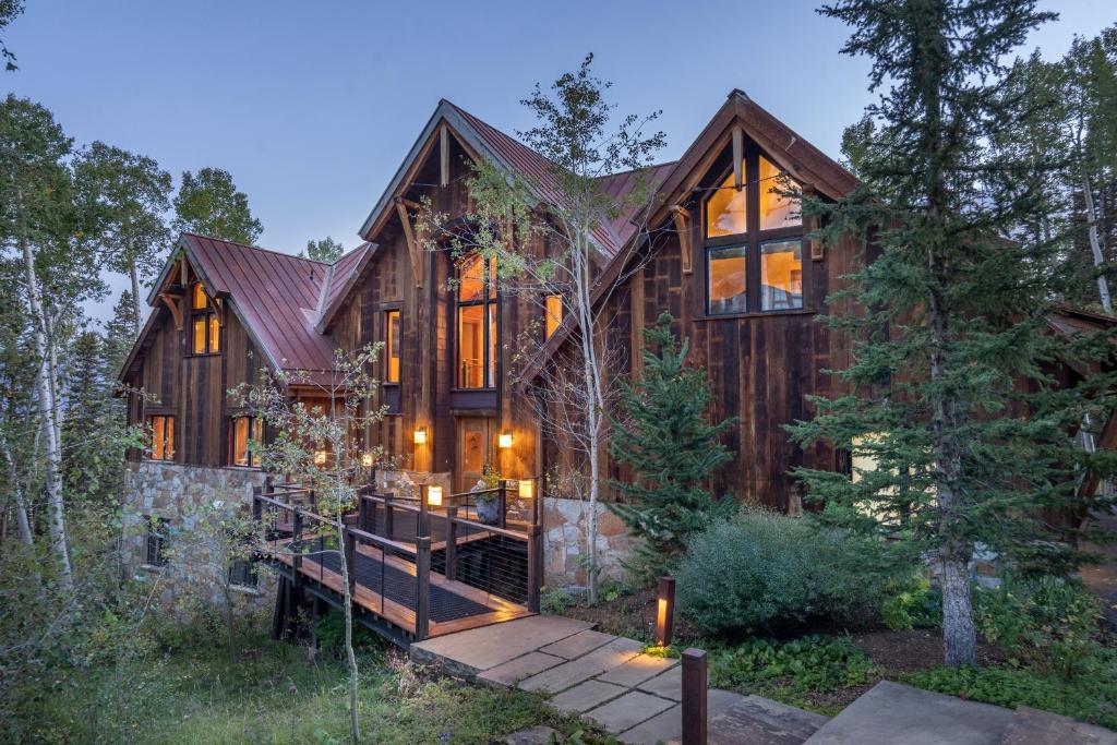a large wooden house with a staircase leading up to it at Alpenglow by Exceptional Stays in Telluride