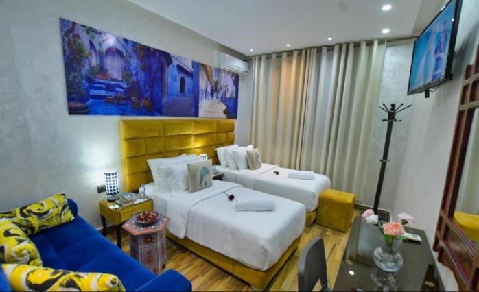 Postel nebo postele na pokoji v ubytování Hotel Dar Annasr