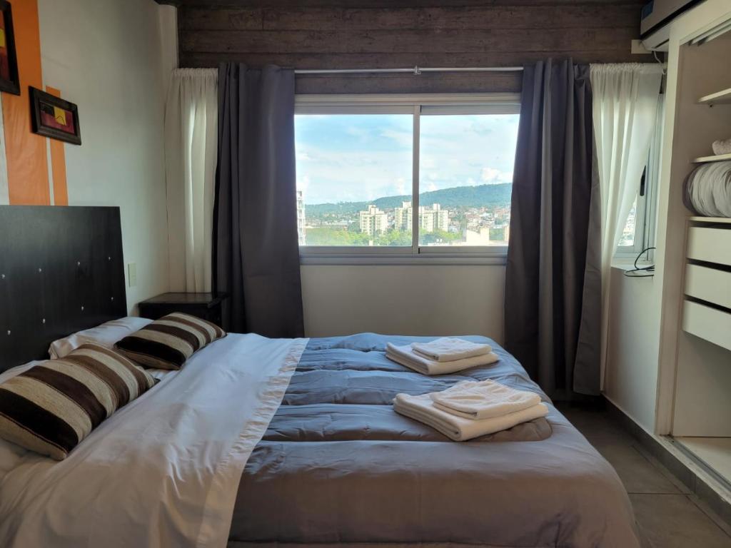 a bedroom with a large bed with towels on it at Los Naranjos in San Salvador de Jujuy