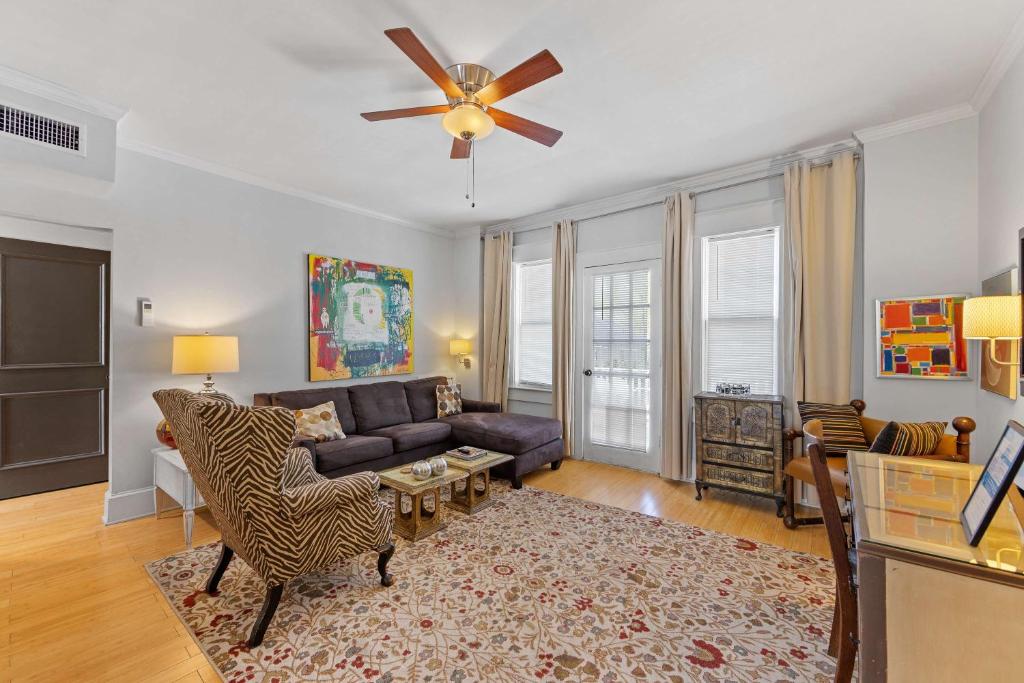 a living room with a couch and a ceiling fan at Chic 1 BR Units Near Dilworth in Charlotte