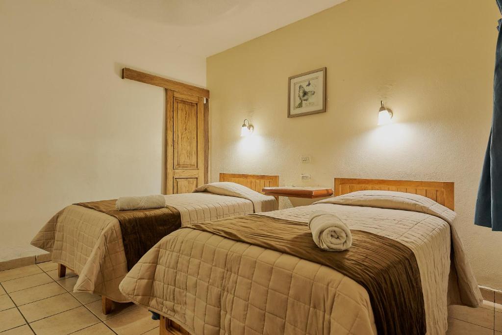 Postel nebo postele na pokoji v ubytování Hotel Cervantino