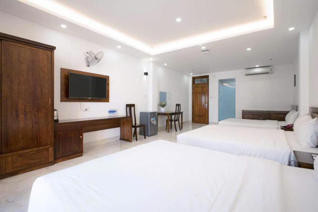 Postel nebo postele na pokoji v ubytování Hồng Gấm Hotel