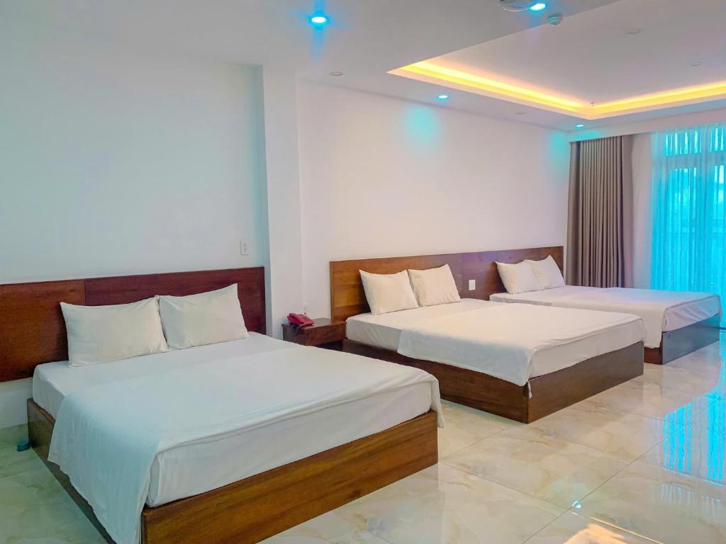 Postel nebo postele na pokoji v ubytování Hồng Gấm Hotel