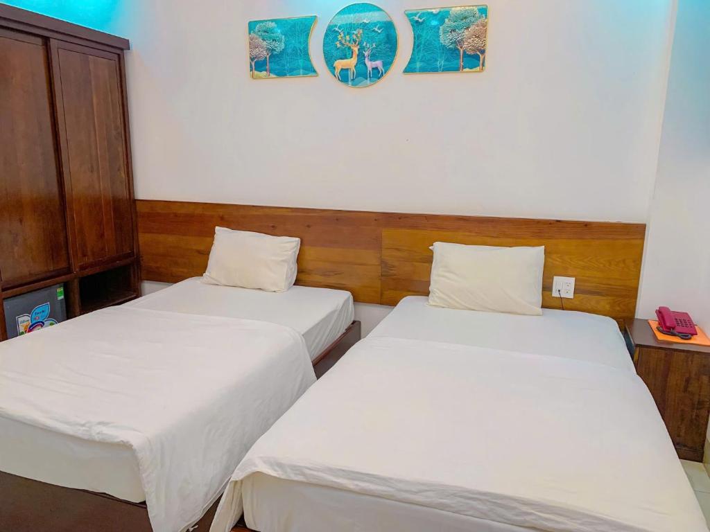 Postel nebo postele na pokoji v ubytování Hồng Gấm Hotel