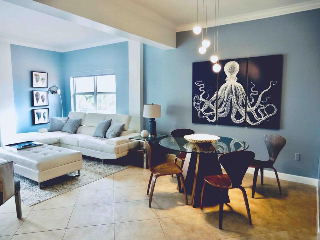 a living room with a couch and a table at The Blue Octopus - 1br King Bed Condo in Fort Lauderdale