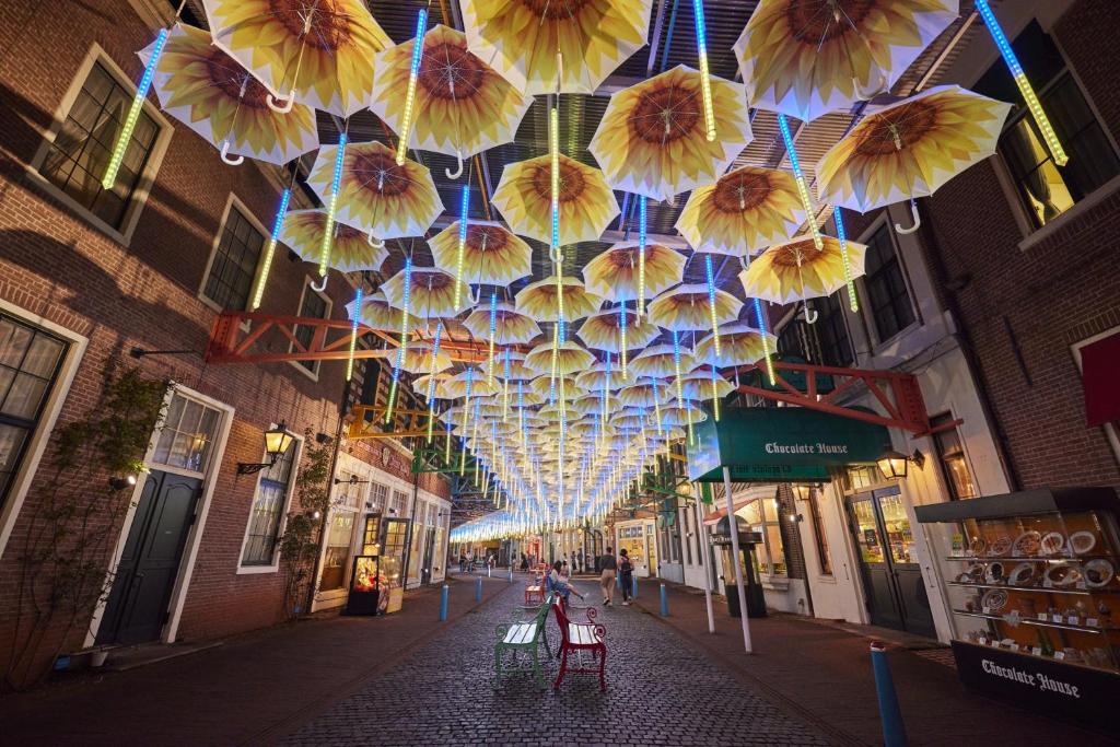 a street with umbrellas hanging from a ceiling at Hotel Amsterdam Huis Ten Bosch in Sasebo