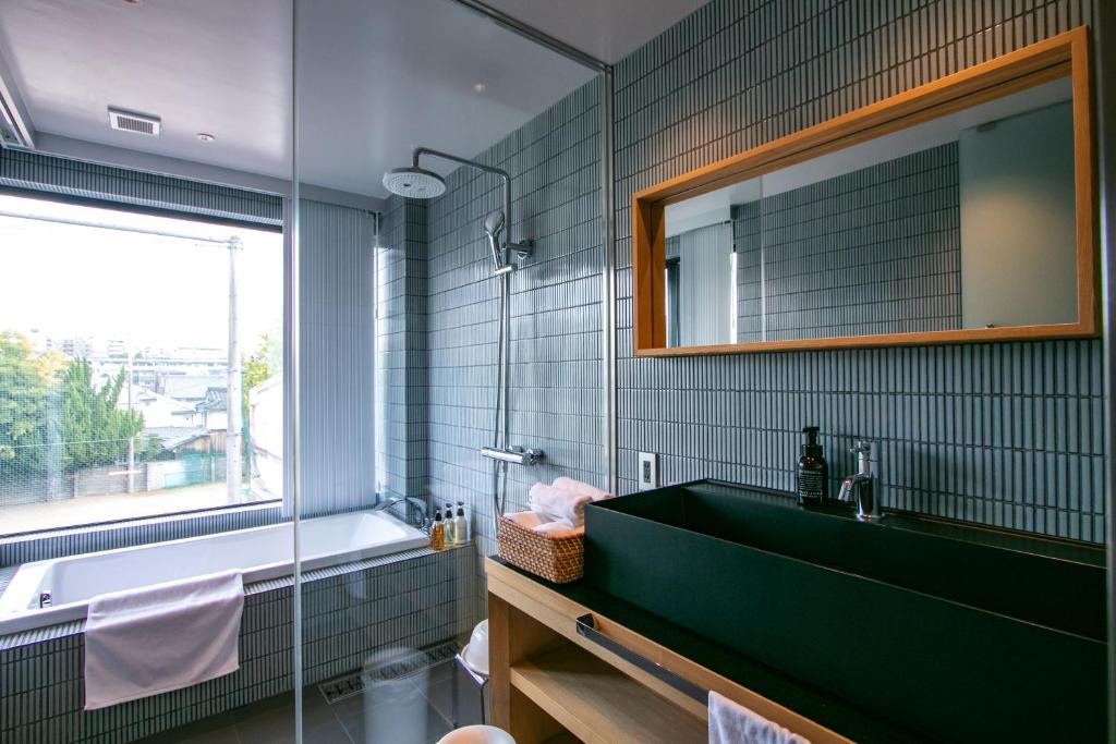 a bathroom with a green sink and a mirror at Minn Nijo-jo in Kyoto