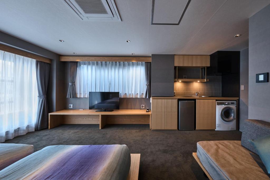 a hotel room with a kitchen and a living room at Minn Nijo-jo in Kyoto