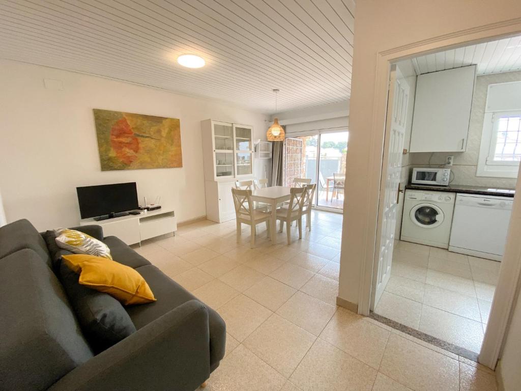 a living room with a couch and a kitchen with a table at Villa in L Escala near Platja d'Empúries in L'Escala