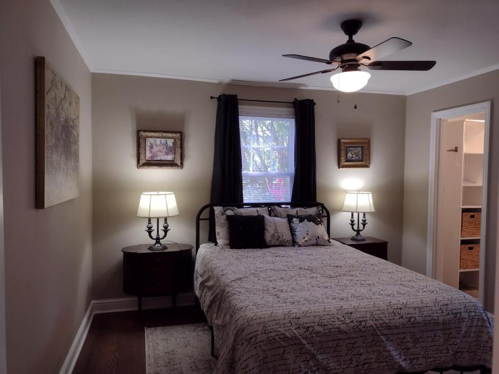 ein Schlafzimmer mit einem Bett und einem Deckenventilator in der Unterkunft Charming, Cozy Cottage Near Downtown New Bern in New Bern