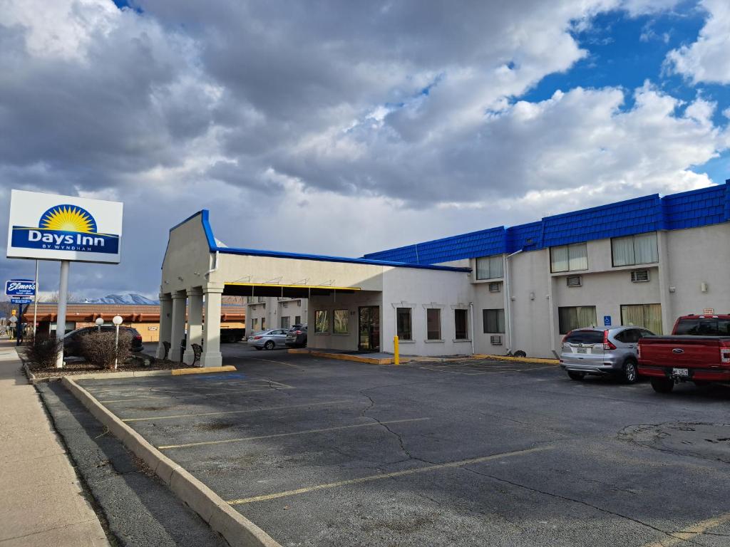 a dfw gas station with cars parked in a parking lot at Days Inn by Wyndham Pocatello University Area in Pocatello