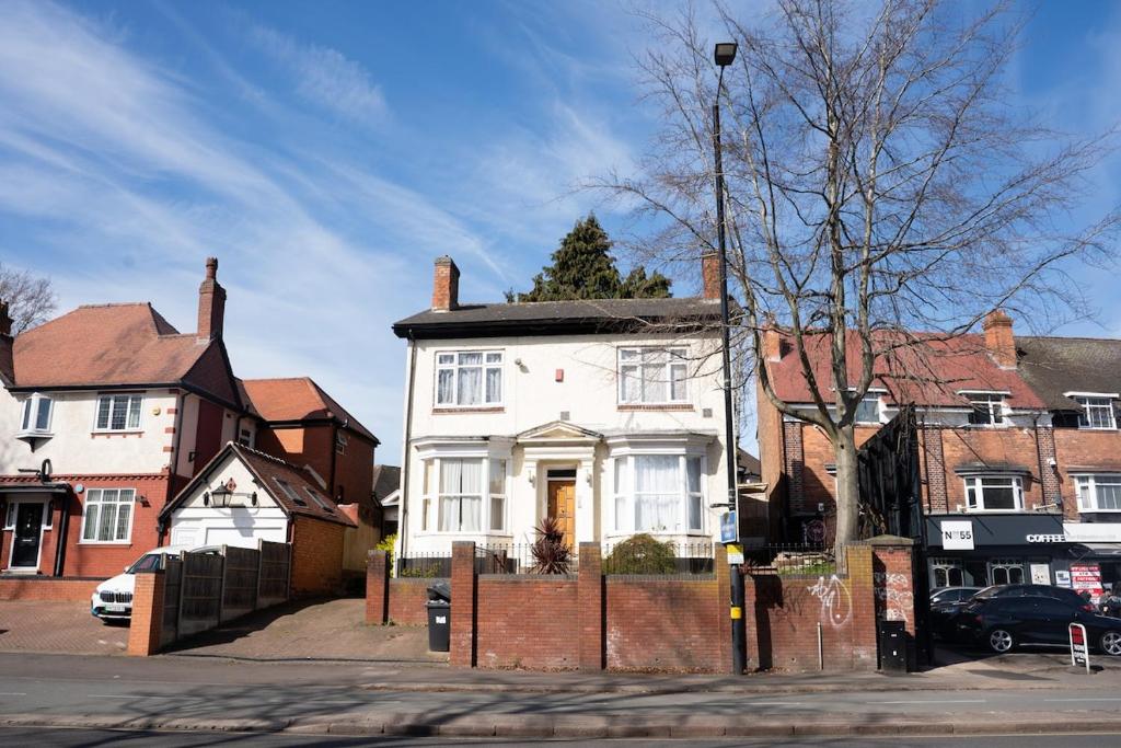 a white house on the side of a street at City Centre 1bed w free parking in Birmingham