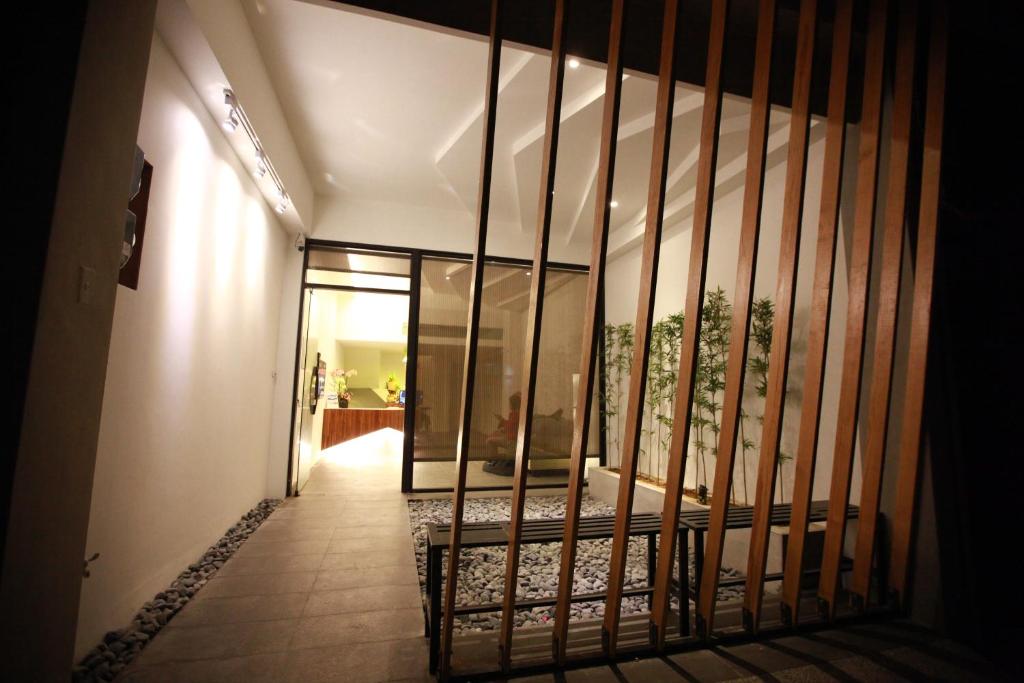 a hallway with a iron gate in a house at Bai Ji Yi B&B in Hengchun