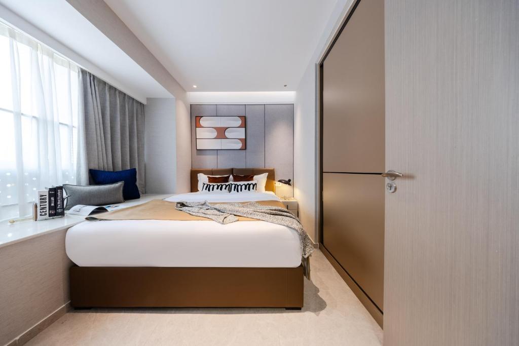 Postel nebo postele na pokoji v ubytování Shenzhen Gangxiahui Executive Apartment Futian Convention and Exhibition Center Branch