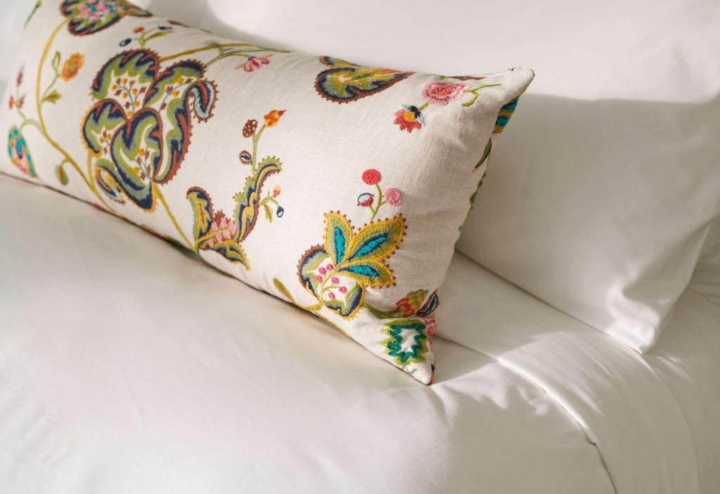 a pillow sitting on top of a white couch at Graduate by Hilton Cambridge in Cambridge