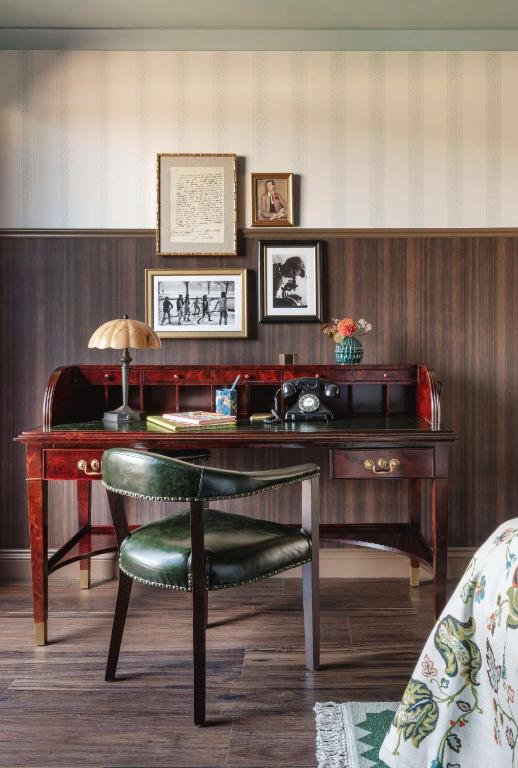 an office with a desk with a chair and a lamp at Graduate by Hilton Cambridge in Cambridge