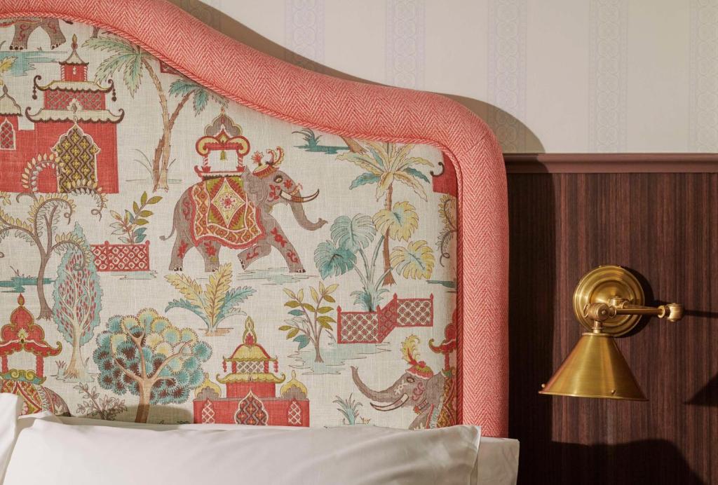 a bedroom with a bed with a tapestry at Graduate by Hilton Cambridge in Cambridge