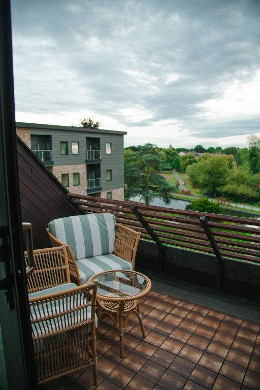 a balcony with a chair and a table on a balcony at Graduate by Hilton Cambridge in Cambridge