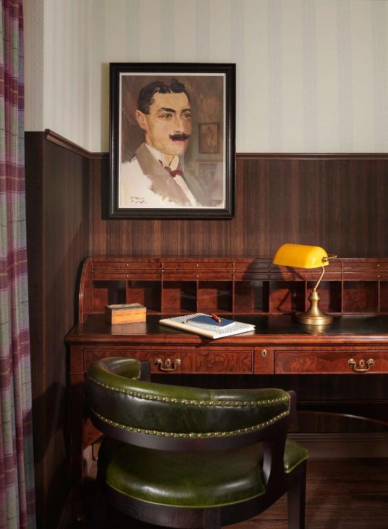 a desk with a picture of a man on it at Graduate by Hilton Cambridge in Cambridge