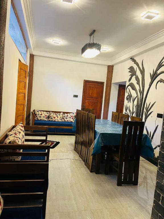 a dining room with a blue table and chairs at Ohiya Alpine River Lodge in Ohiya
