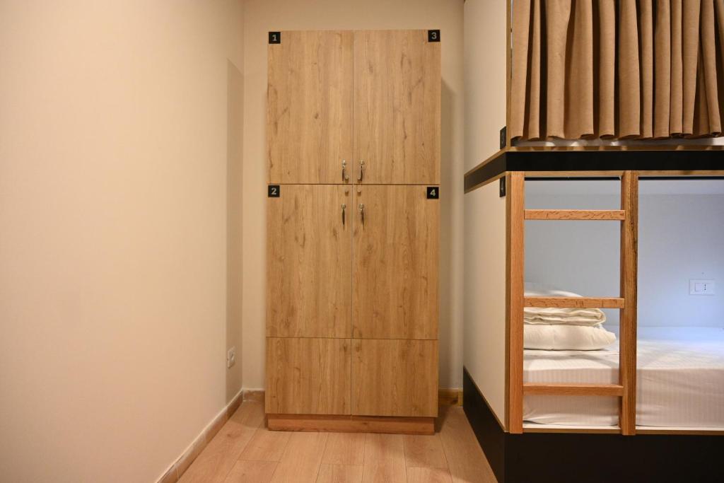 a room with a bunk bed and a closet at Top view hostel in Durrës