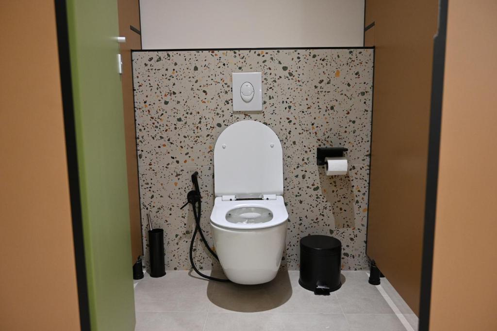 a bathroom with a white toilet in a stall at Top view hostel in Durrës