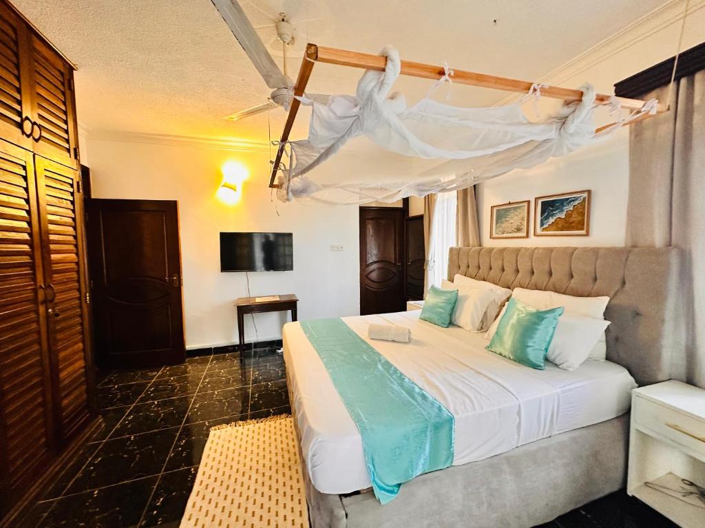 a bedroom with a white bed with a canopy at A private room in,Coastal Bliss homestsy in Mombasa