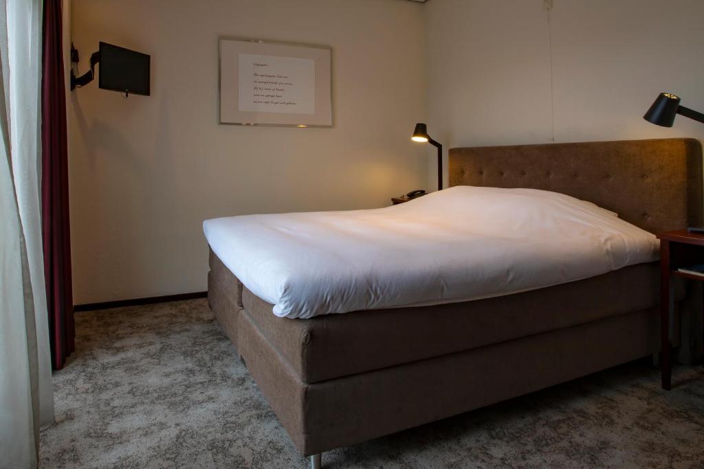 Postel nebo postele na pokoji v ubytování Hotel Greenside Texel