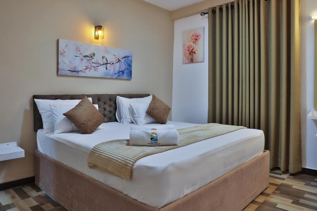 a bedroom with a large bed in a room at Kandy River Lodge in Kandy