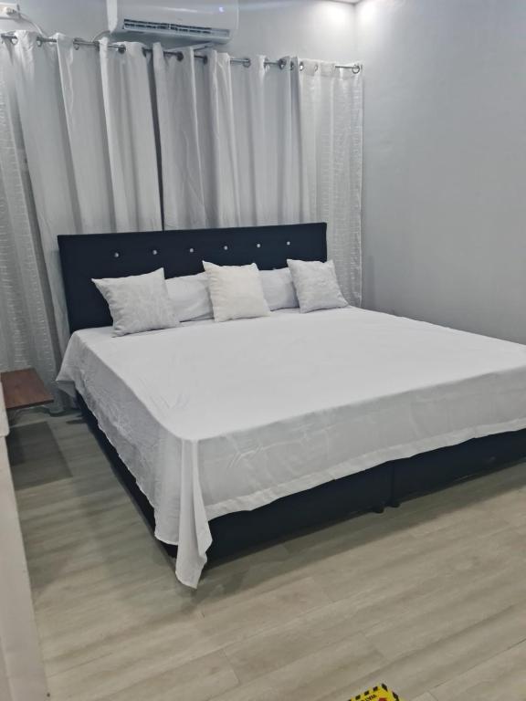 a bedroom with a large bed with white sheets and pillows at Diamonds Exclusive Resort in Diamond