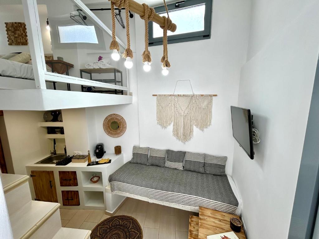 a small room with a bed in the middle of a house at Babatseratsi skyrian studio 1 in Skiros