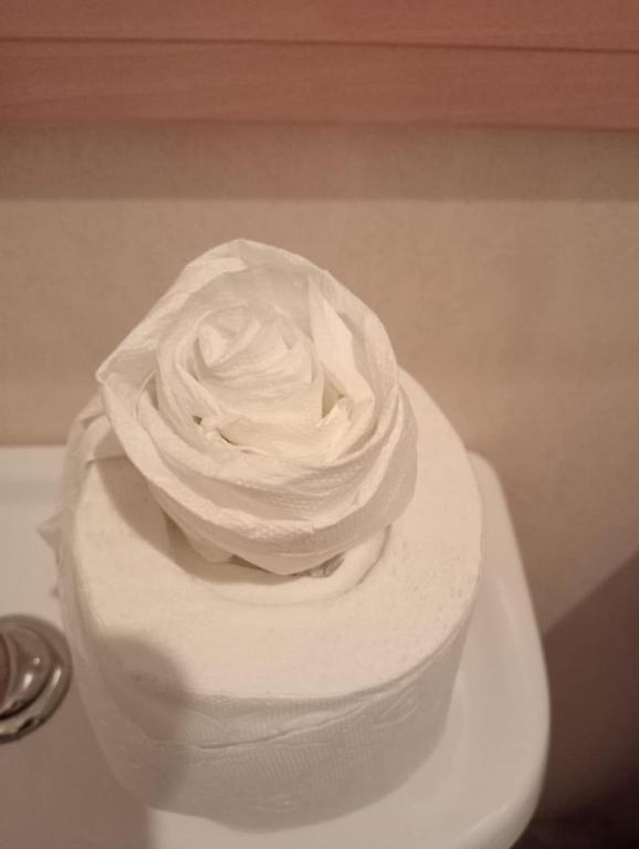 a white wedding cake with a white rose on top at Seaside chalet in Ardmore with breathtaking views in Ardmore