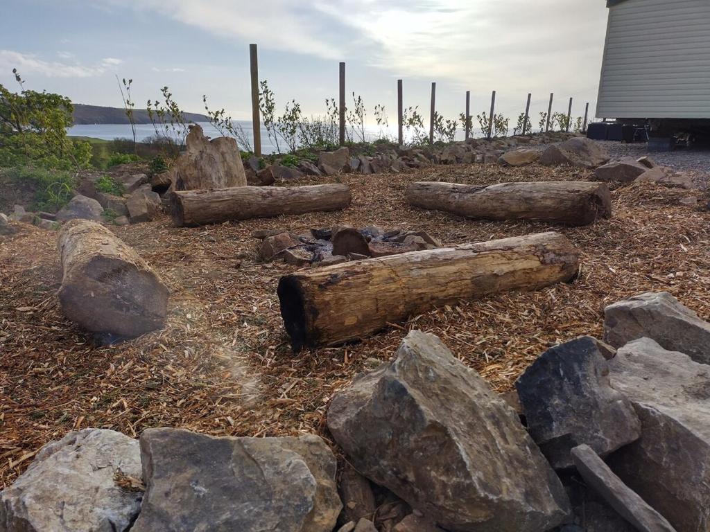 a group of logs and rocks on the ground at Seaside chalet in Ardmore with breathtaking views in Ardmore