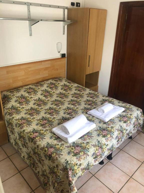 A bed or beds in a room at BE ME Hotel Helvetia