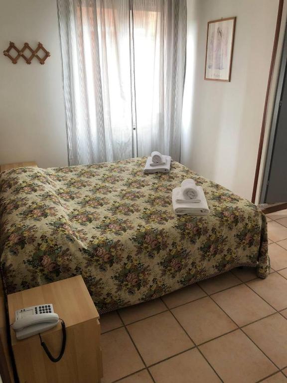 A bed or beds in a room at BE ME Hotel Helvetia