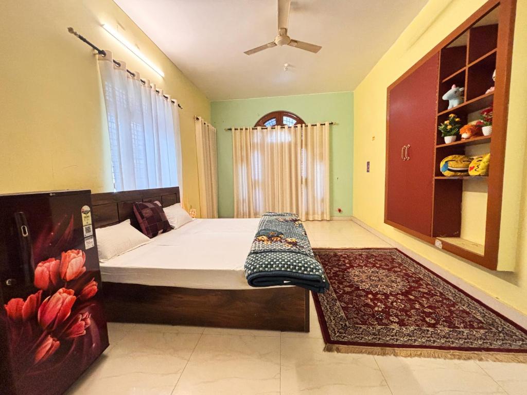 a bedroom with a bed in a room with a rug at Jai Villa Homestay in Prayagraj