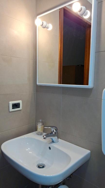 a white sink in a bathroom with a mirror at Locanda El Piron in Chiampo