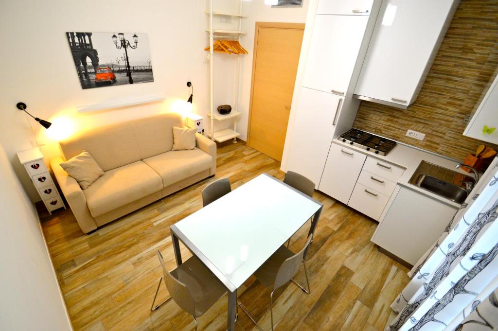 a living room with a couch and a table at Royal Sea House in Cefal&ugrave;