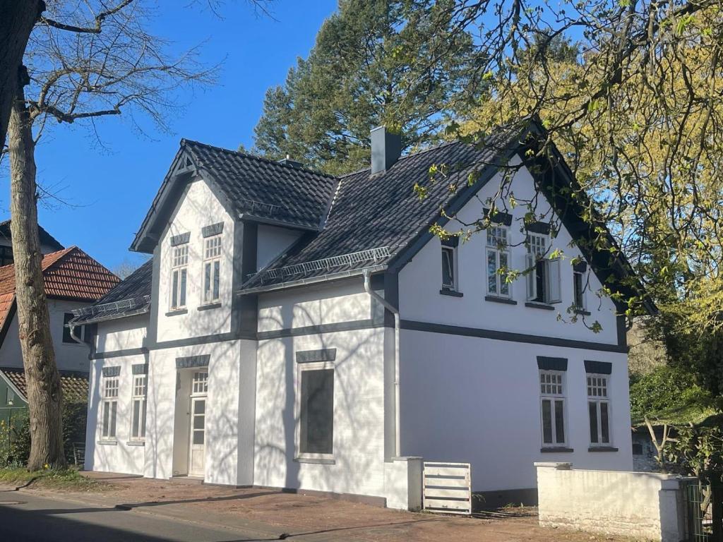 a white house with a black roof at Ferienpark Worpswede in Worpswede