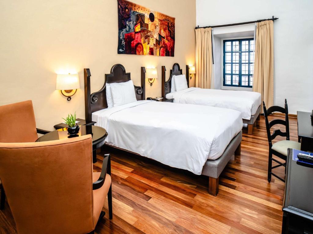 Postel nebo postele na pokoji v ubytování Novotel Cusco