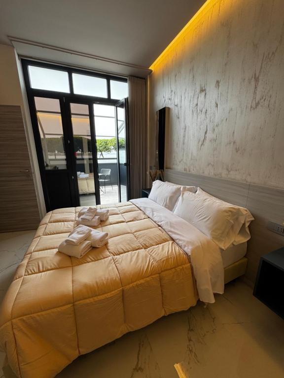 a bedroom with a large bed with towels on it at Blue Seagull Guest House in Chiavari