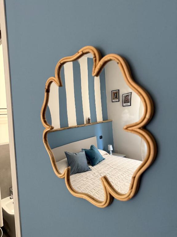 a bedroom with a heart shaped mirror on the wall at Rooms primo piano in Modena