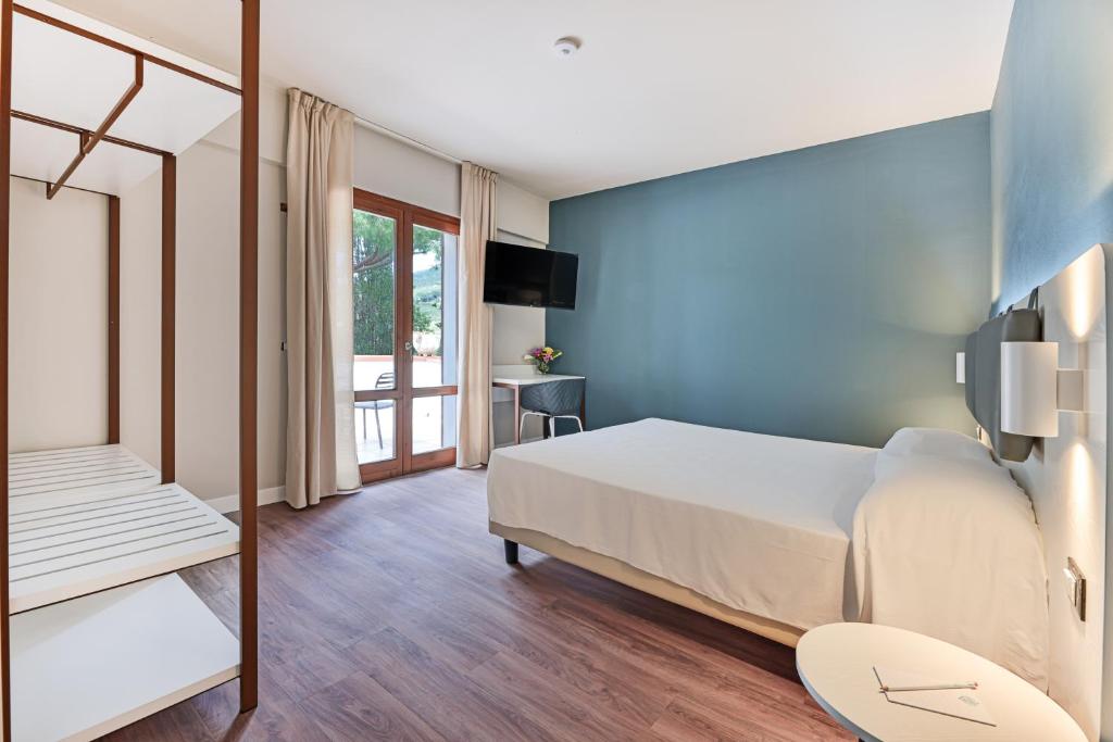 Postel nebo postele na pokoji v ubytování Elba Vibe Smart Hotel