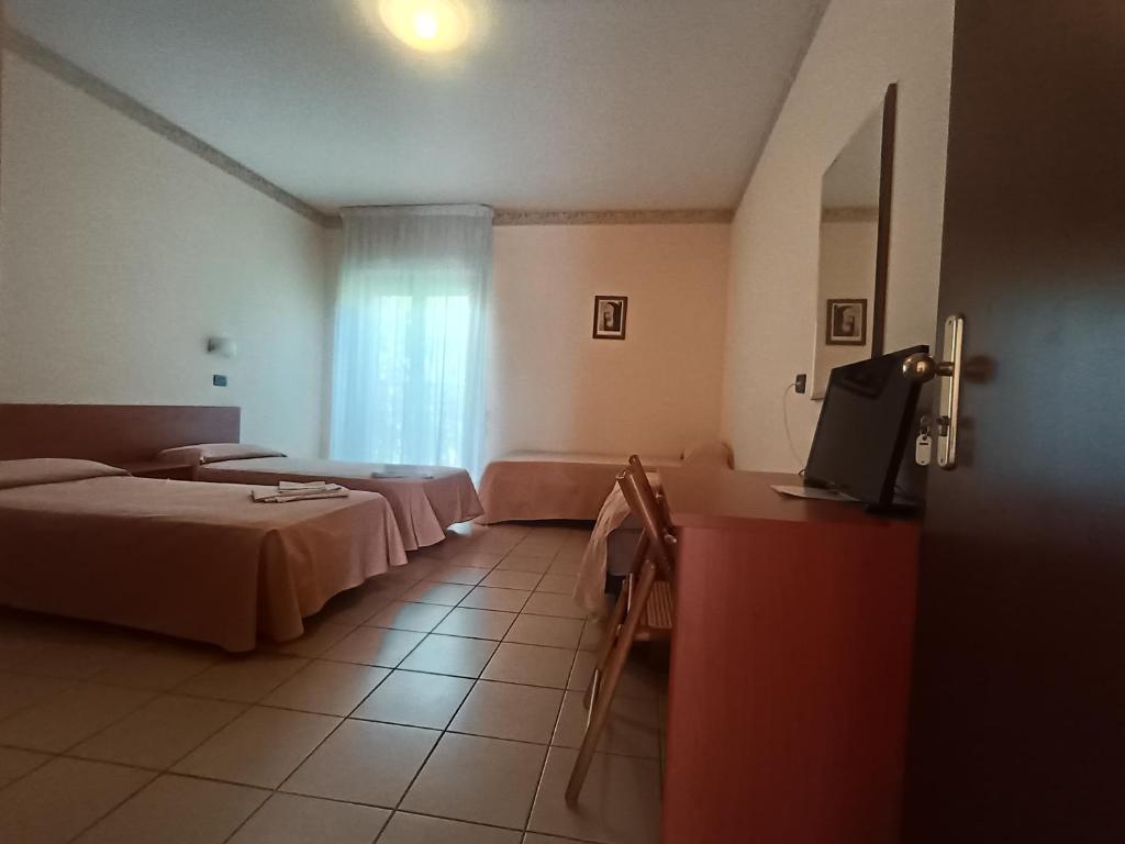 Postel nebo postele na pokoji v ubytování Hotel Sirios
