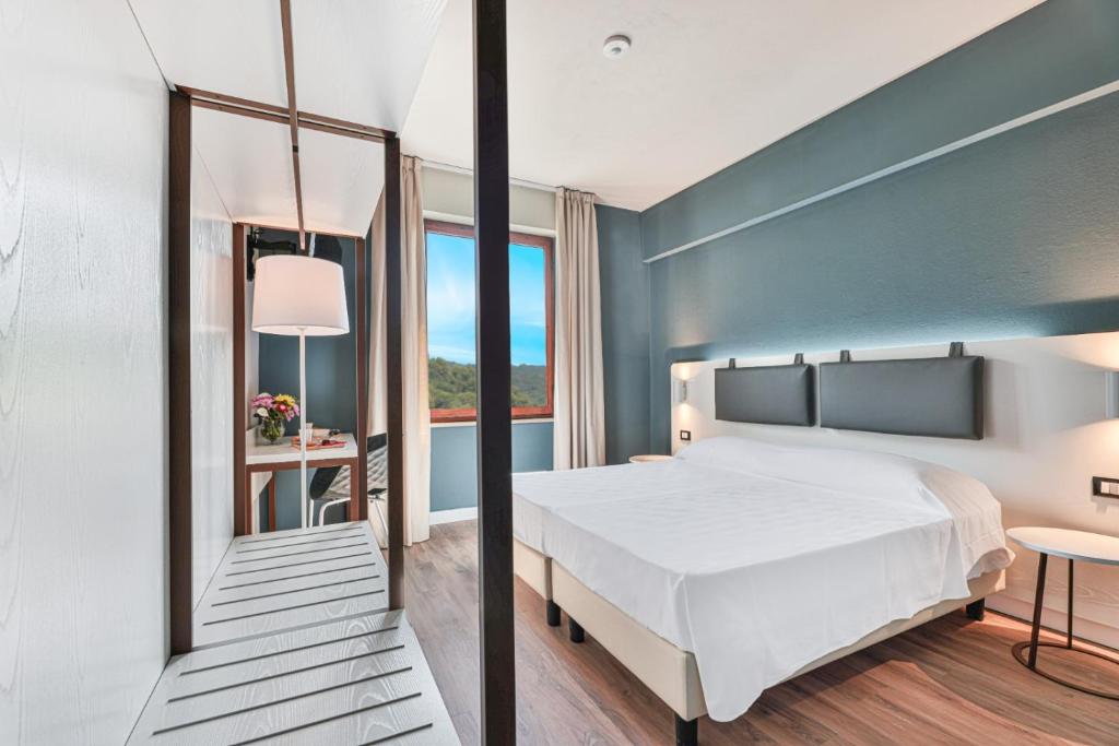 Postel nebo postele na pokoji v ubytování Elba Vibe Smart Hotel