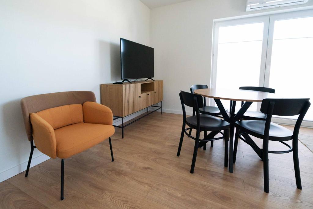 Televízia a/alebo spoločenská miestnosť v ubytovaní Aparthotel Weissa 7