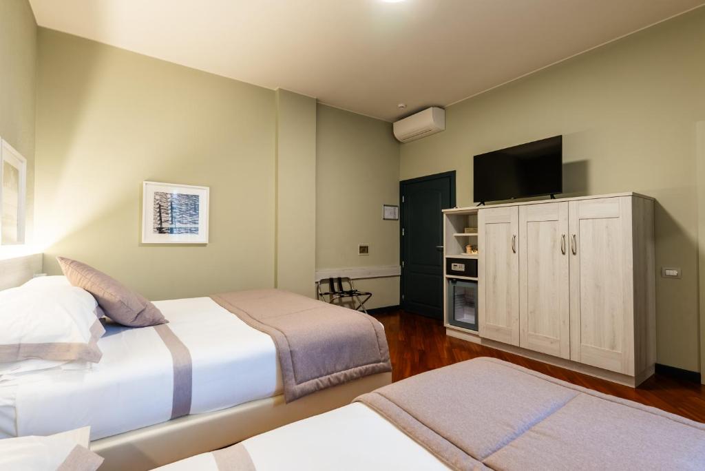 Postel nebo postele na pokoji v ubytování Hotel Centrale